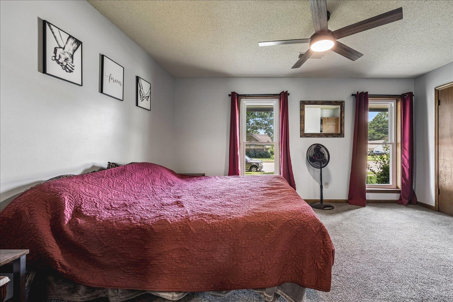 3284 Altruria Road Bartlett, TN 38134 - Photo 17 of 28 Bedroom featuring two windows providing natural light, a ceiling fan with integrated lighting, textured carpeting, and a light-colored wall finish