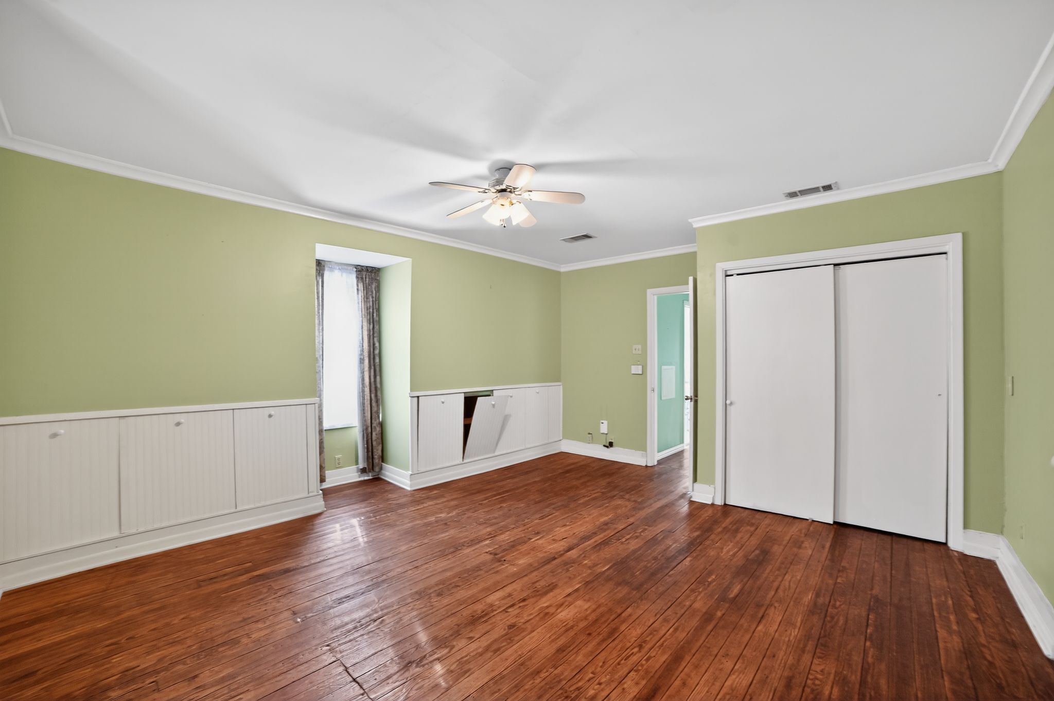 400 South Main Street Belton, TX 76513 - Photo 15 of 18 Unfurnished bedroom with ornamental molding, dark wood finished floors, a closet, and a ceiling fan