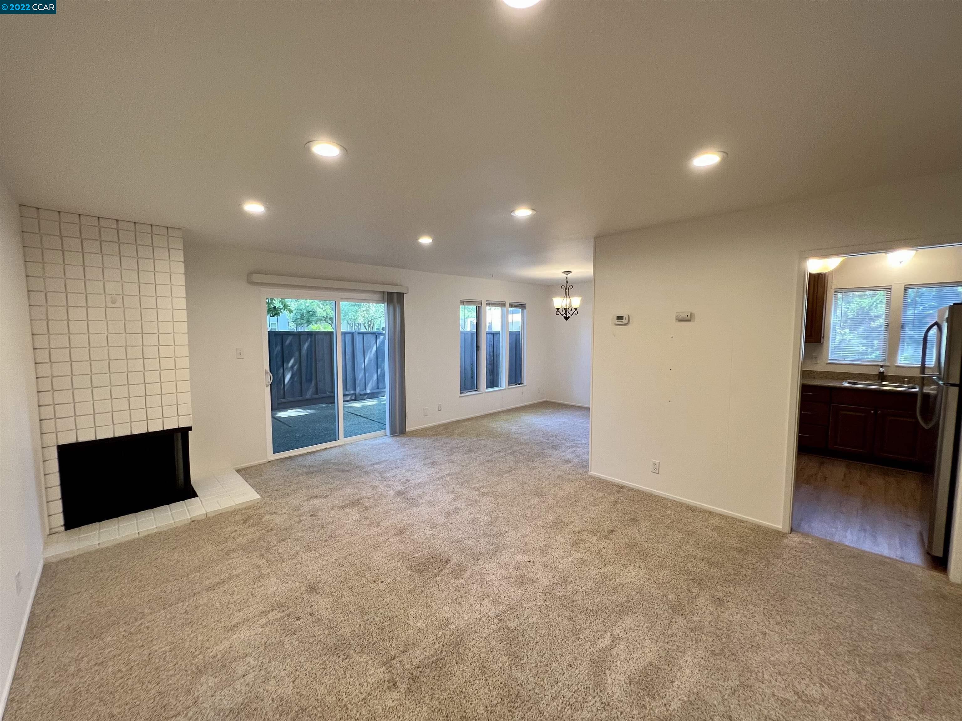 2060 Camel Lane, Unit 4 Walnut Creek, CA 94596 - Photo 1 of 33 a view of an empty room with a fireplace and a window