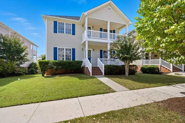 a front view of house with yard and green space