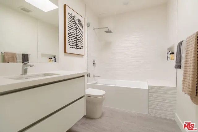 a bathroom with a sink a toilet and a bathtub