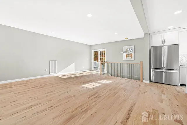 a view of a kitchen with wooden floor and a sink