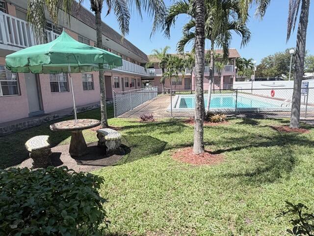 6050 Southwest 27th Street Miramar, FL 33023 - Photo 3 of 40 a swimming pool with outdoor seating and yard
