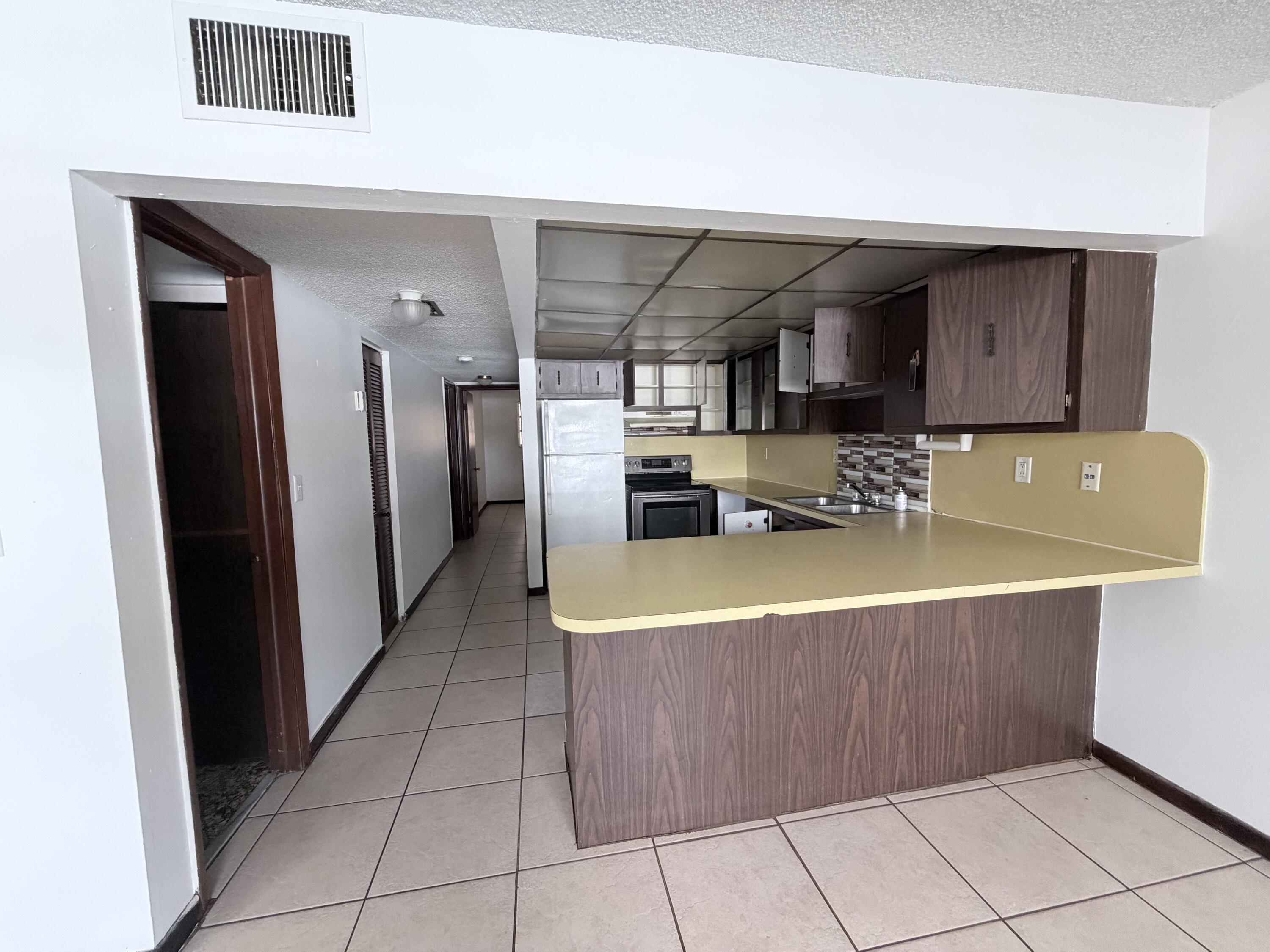 6050 Southwest 27th Street Miramar, FL 33023 - Photo 6 of 40 a kitchen with stainless steel appliances granite countertop a refrigerator and a stove