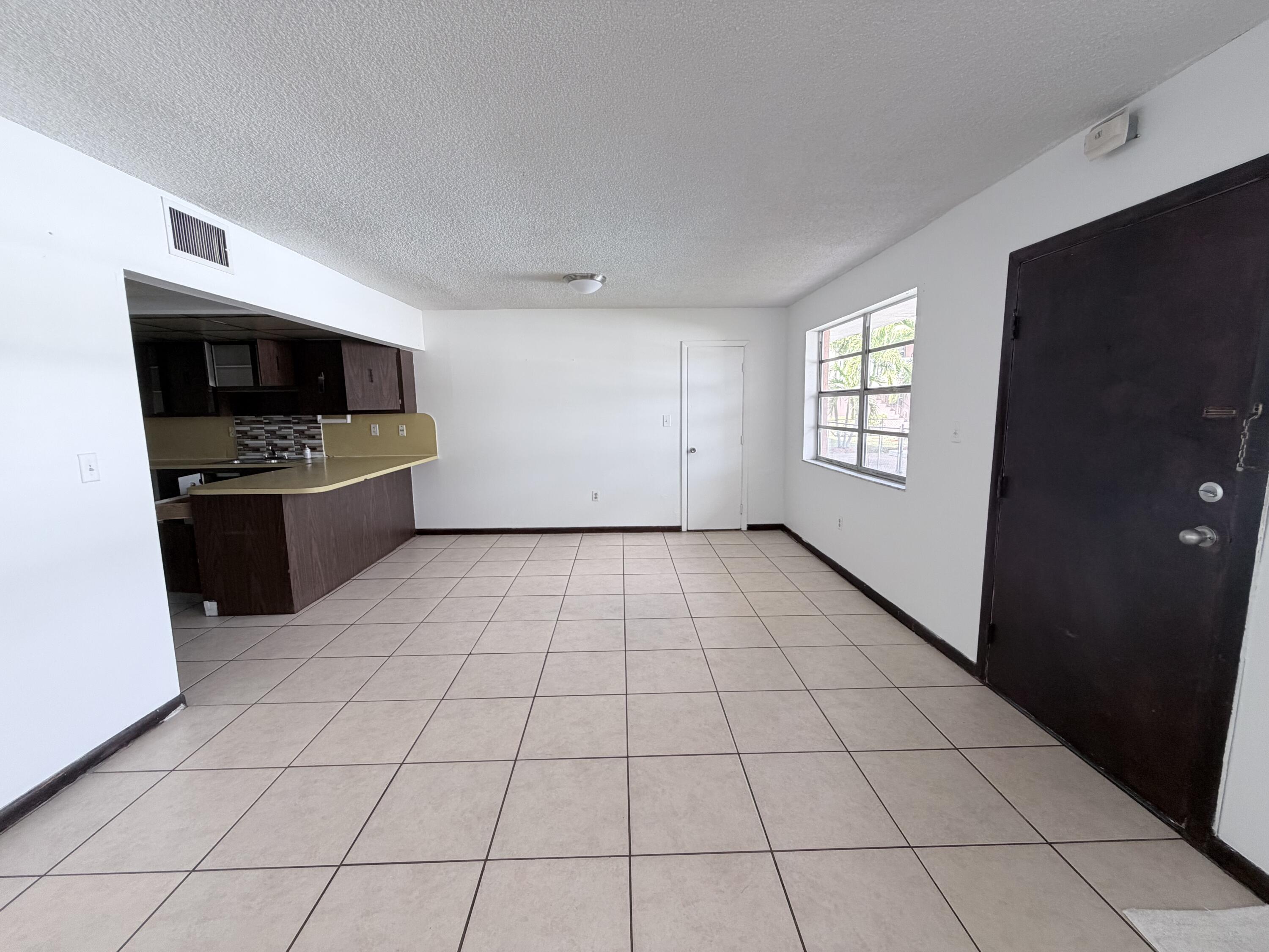 6050 Southwest 27th Street Miramar, FL 33023 - Photo 8 of 40 a view of an empty room with a kitchen