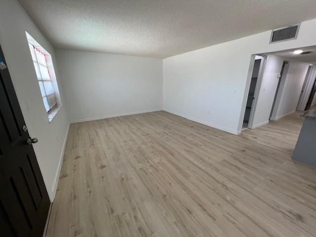 6050 Southwest 27th Street Miramar, FL 33023 - Photo 9 of 40 an empty room with wooden floor and staircase