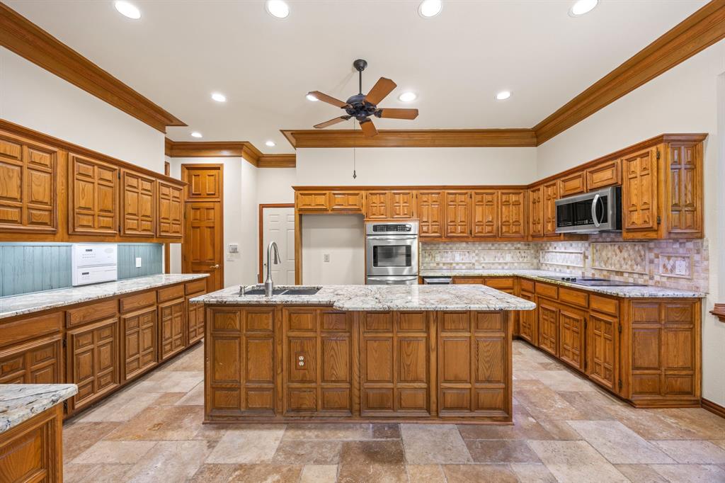 801 Spring Canyon Drive Irving, TX 75063 - Photo 11 of 40 a kitchen with stainless steel appliances granite countertop a sink and cabinets