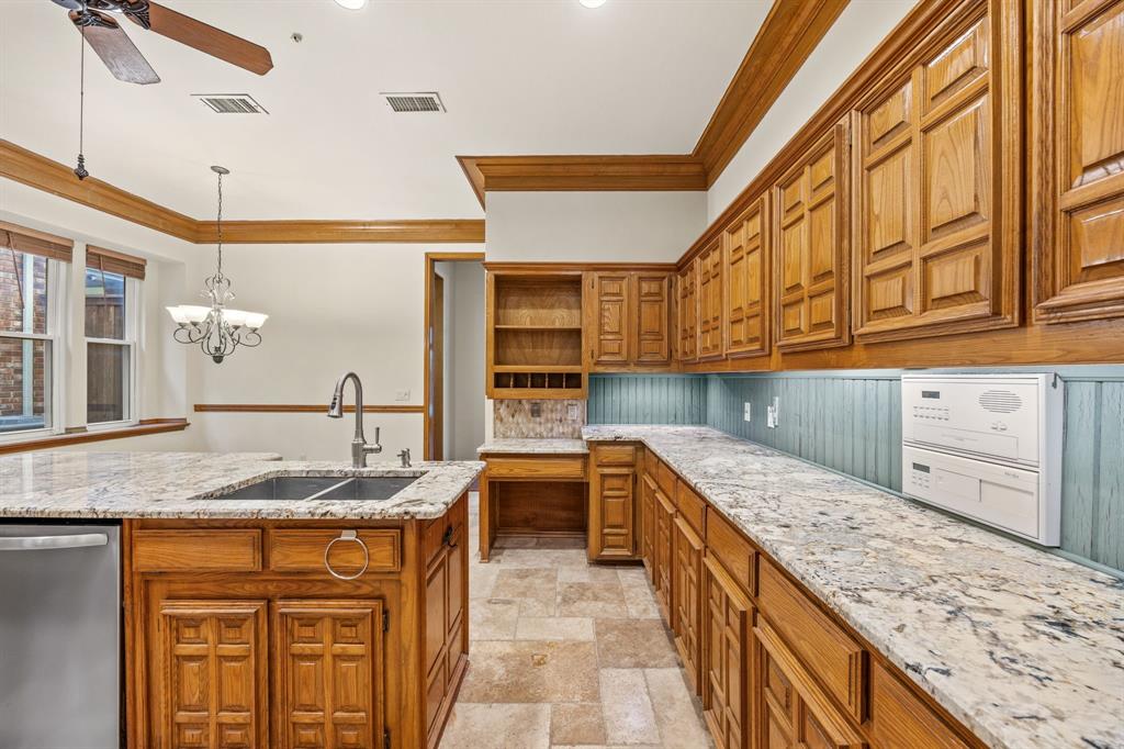 801 Spring Canyon Drive Irving, TX 75063 - Photo 12 of 40 a kitchen with stainless steel appliances granite countertop a sink and cabinets