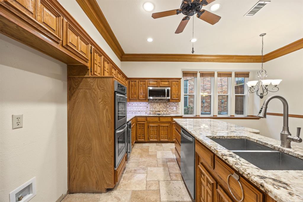 801 Spring Canyon Drive Irving, TX 75063 - Photo 14 of 40 a kitchen with granite countertop a sink and a refrigerator