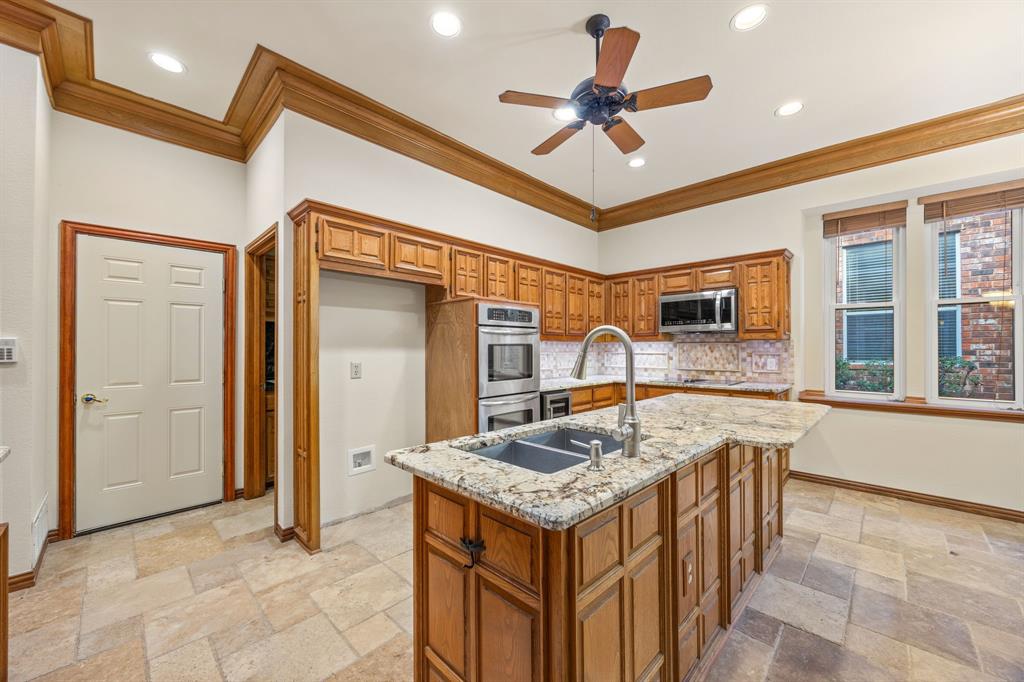801 Spring Canyon Drive Irving, TX 75063 - Photo 15 of 40 a kitchen with stainless steel appliances granite countertop a sink and a refrigerator