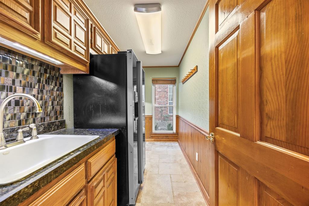 801 Spring Canyon Drive Irving, TX 75063 - Photo 16 of 40 a view of a kitchen with a sink and a refrigerator