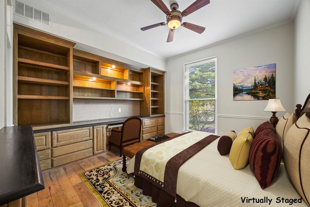 801 Spring Canyon Drive Irving, TX 75063 - Photo 18 of 40 a bedroom with a bed and a chandelier