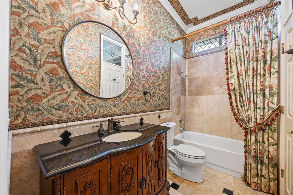 801 Spring Canyon Drive Irving, TX 75063 - Photo 19 of 40 a bathroom with a sink a toilet and a mirror