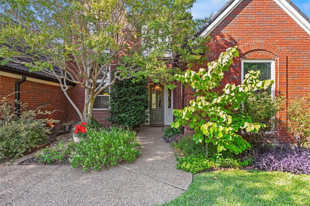 801 Spring Canyon Drive Irving, TX 75063 - Photo 2 of 40 a front view of a house with lots of green space
