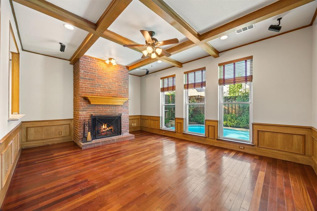 801 Spring Canyon Drive Irving, TX 75063 - Photo 22 of 40 a view of an empty room with wooden floor fireplace and a window