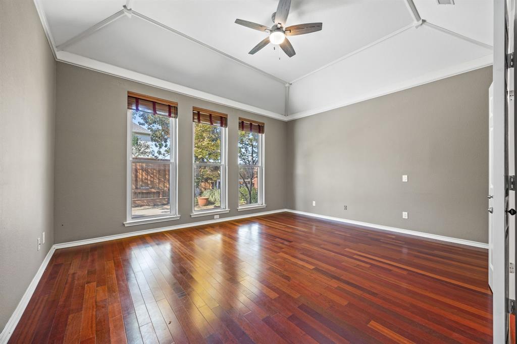 801 Spring Canyon Drive Irving, TX 75063 - Photo 24 of 40 a view of an empty room with wooden floor and a window