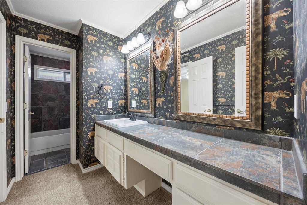 801 Spring Canyon Drive Irving, TX 75063 - Photo 34 of 40 a bathroom with a granite countertop sink and mirror