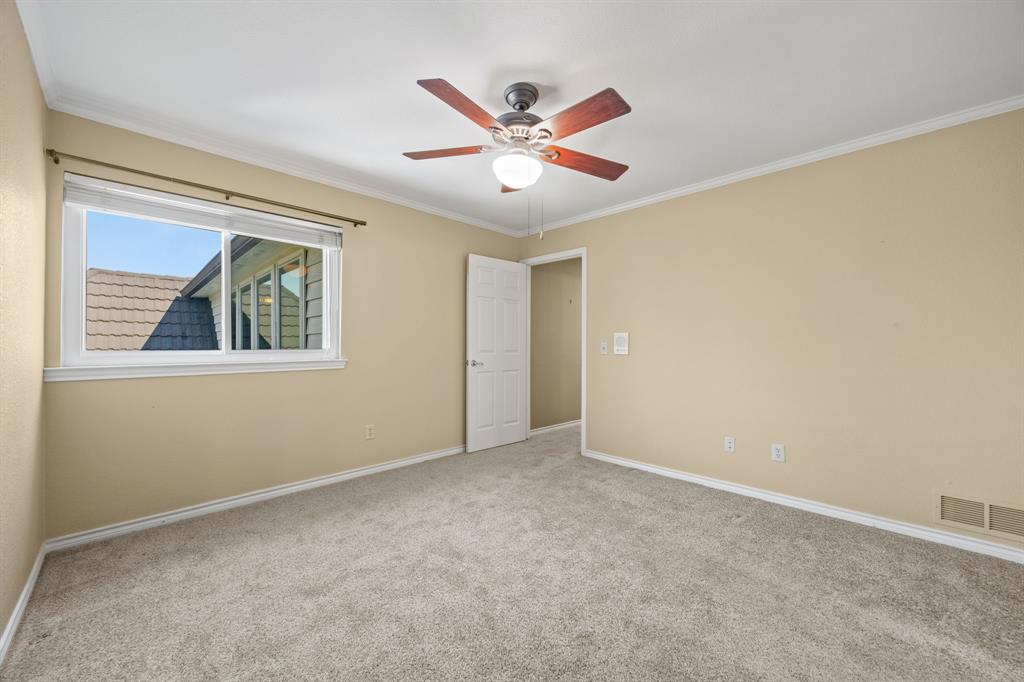 801 Spring Canyon Drive Irving, TX 75063 - Photo 35 of 40 a view of an empty room with a ceiling fan