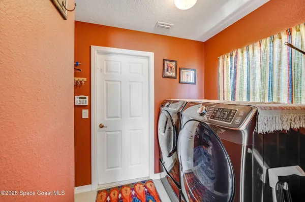 a view of walk in closet with clothes