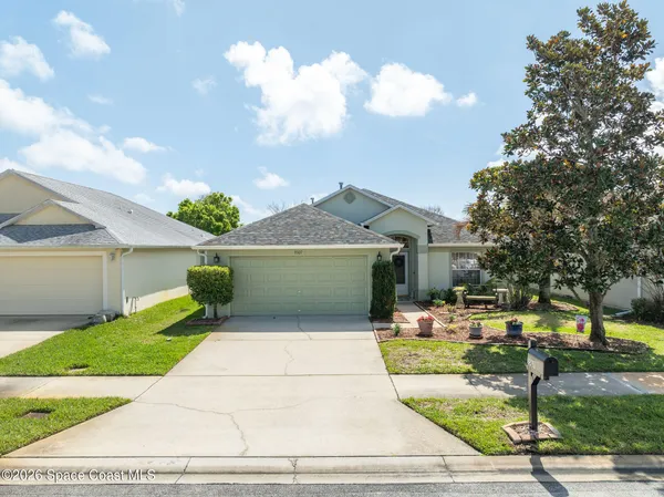 a living room with furniture a dining table and a potted plant
