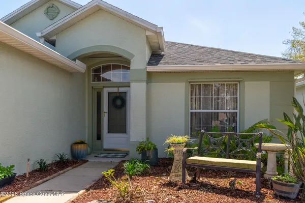 a view of a dining room with furniture and a chandelier