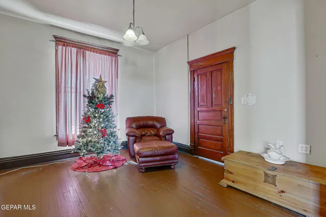 a living room with furniture and flowers