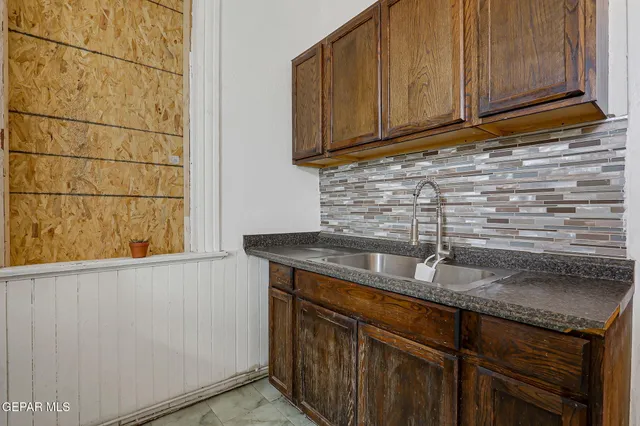a kitchen with granite countertop cabinets sink and cabinets