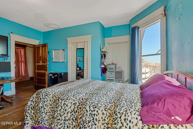 a bedroom with a large bed and a dresser