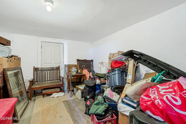 a living room with furniture a flat screen tv and a couch