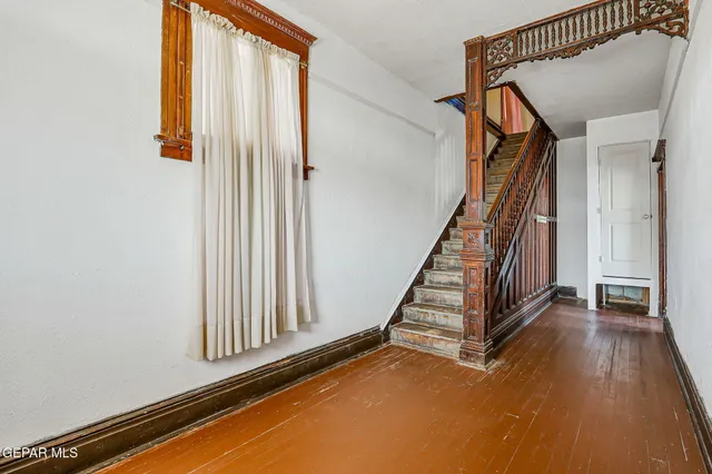 an entryway with stairs and a window