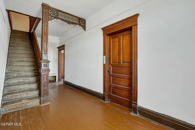a view of a hallway with closet and wooden floor