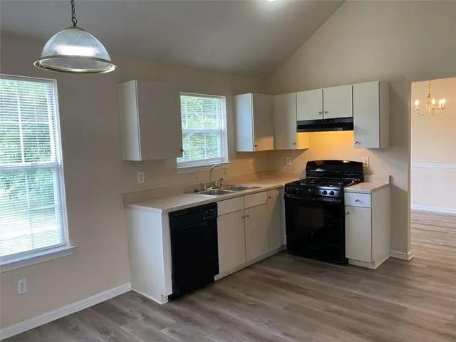 a kitchen with granite countertop a stove and a sink