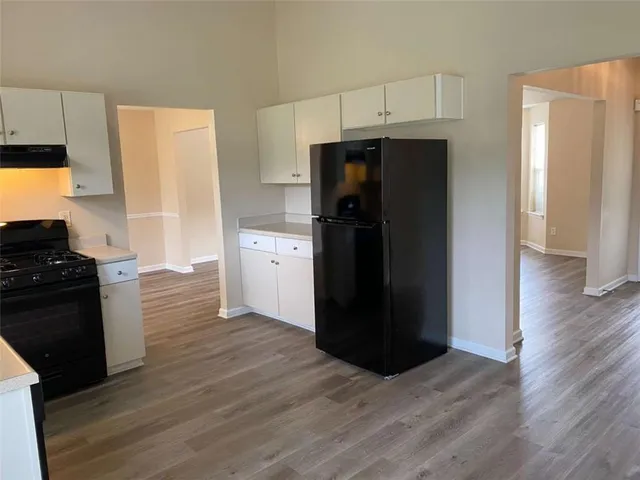 a kitchen with a refrigerator and a stove