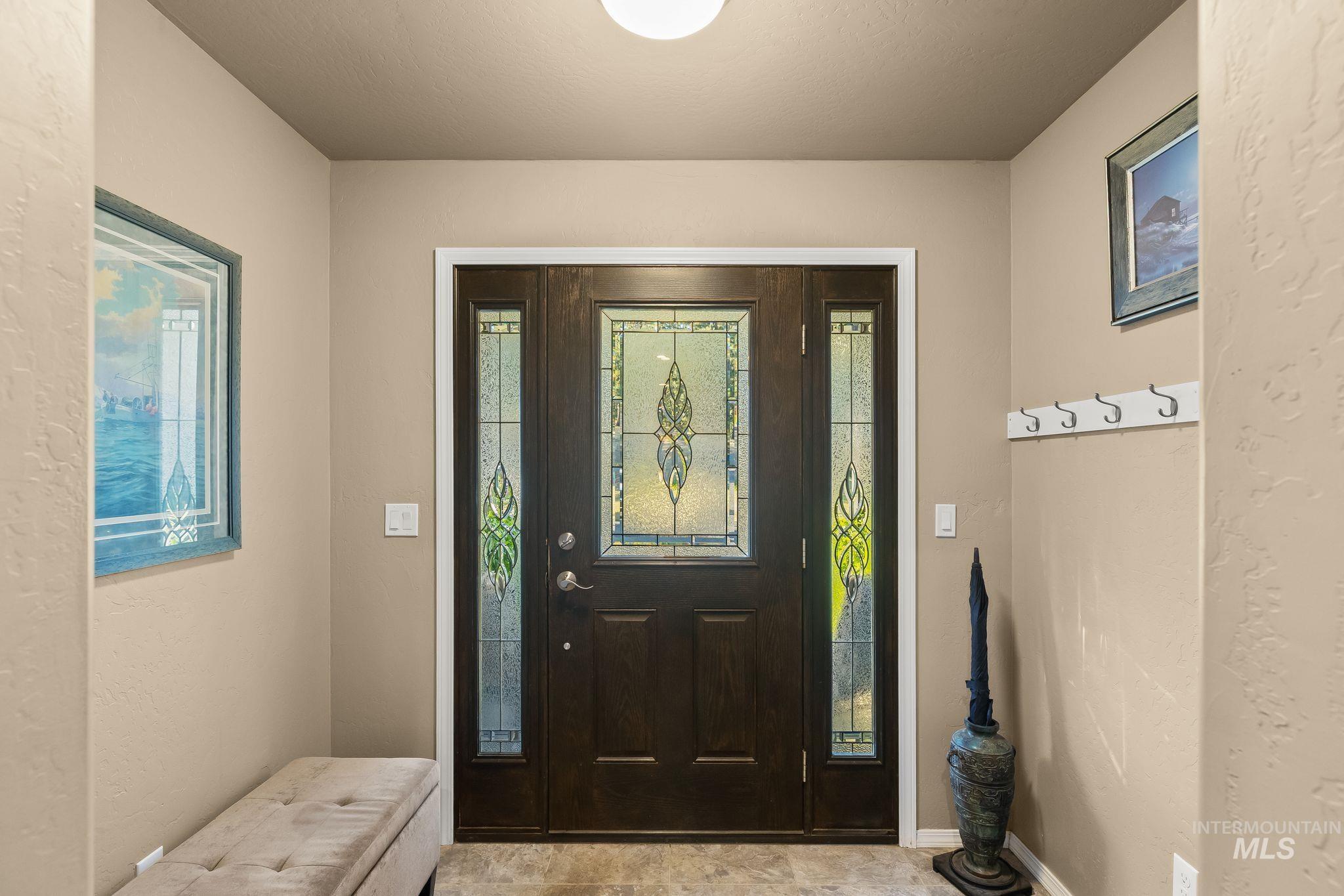435 River Pointe Lane Lenore, ID 83541 - Photo 7 of 50 Entryway featuring a dark wood-finish door with decorative stained glass, flanked by two stained glass sidelights