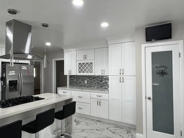 a kitchen with a sink a stove and cabinets