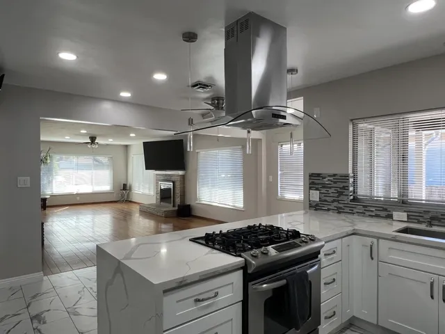 a kitchen with stainless steel appliances granite countertop a stove and a sink