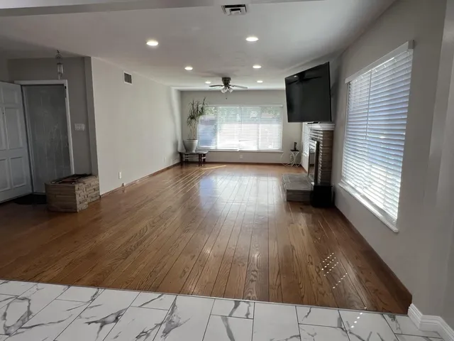 a view of kitchen with refrigerator and window