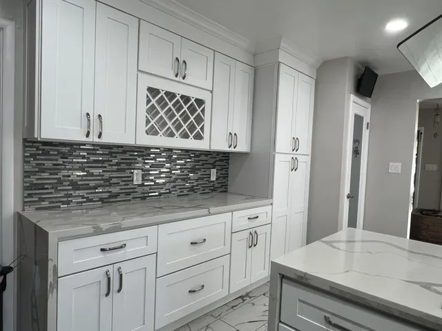 a kitchen with white cabinets
