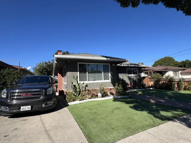a view of house with backyard space and garden