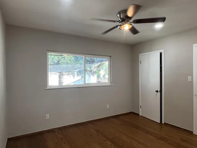 wooden floor in an empty room with a window