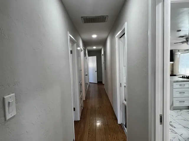 a view of hallway with wooden floor