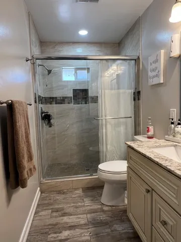 a bathroom with a sink toilet and shower