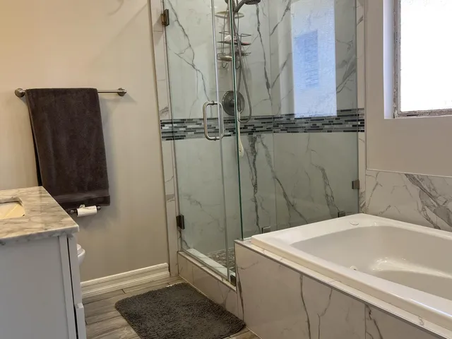 a kitchen with stainless steel appliances kitchen island granite countertop a refrigerator and microwave