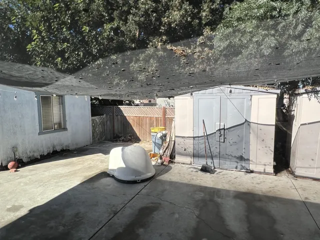 a view of a patio with table and chairs