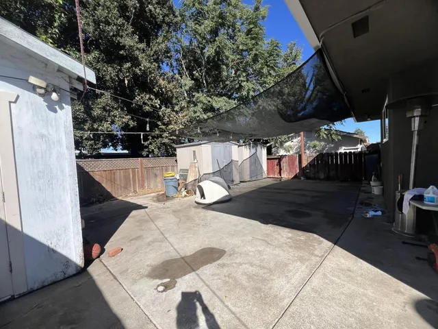 a view of a room that has a window and a wooden floor