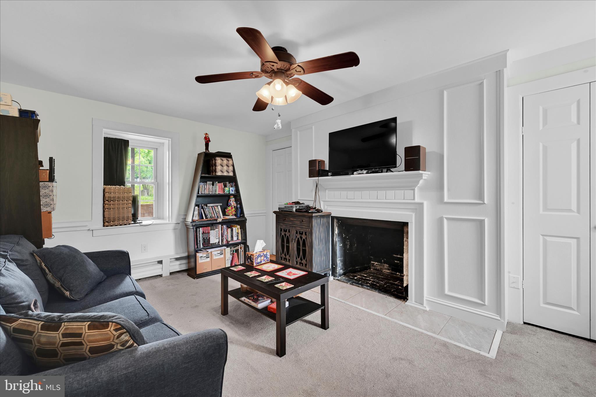 286 Schuylkill Road Birdsboro, PA 19508 - Photo 7 of 39 a living room with furniture a flat screen tv and a fireplace