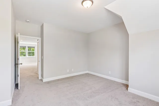 an empty room with a ceiling fan and a window
