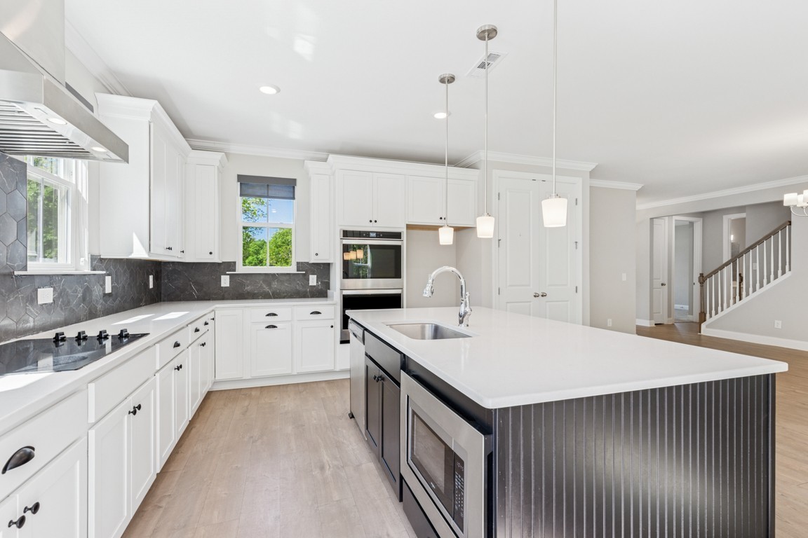 7205 Lake Road Northwest Fairview, TN 37062 - Photo 7 of 28 a kitchen with a sink stove and cabinets