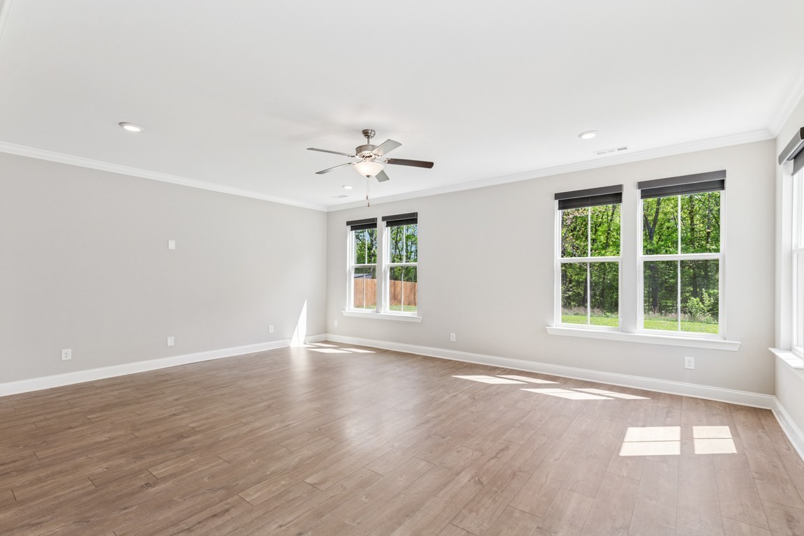 7205 Lake Road Northwest Fairview, TN 37062 - Photo 9 of 28 an empty room with wooden floor and windows