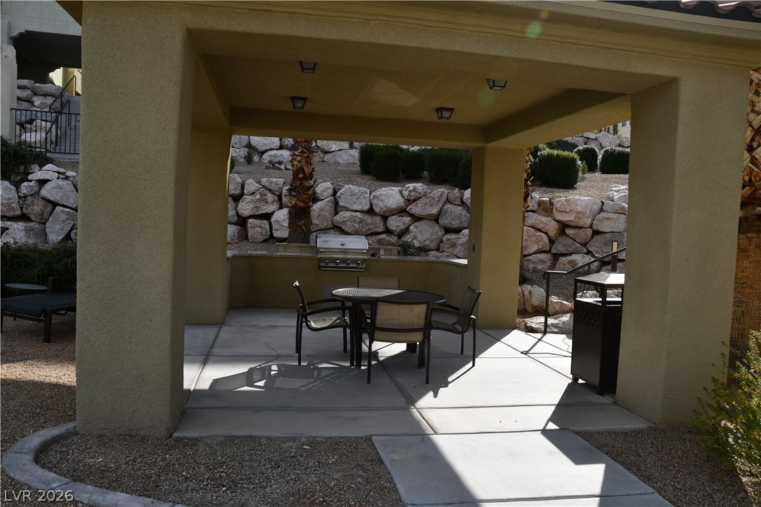 2555 Hampton Road, Unit 7109 Henderson, NV 89052 - Photo 7 of 34 An inviting outdoor kitchen area with built-in barbecue and dining space awaits al fresco meals.